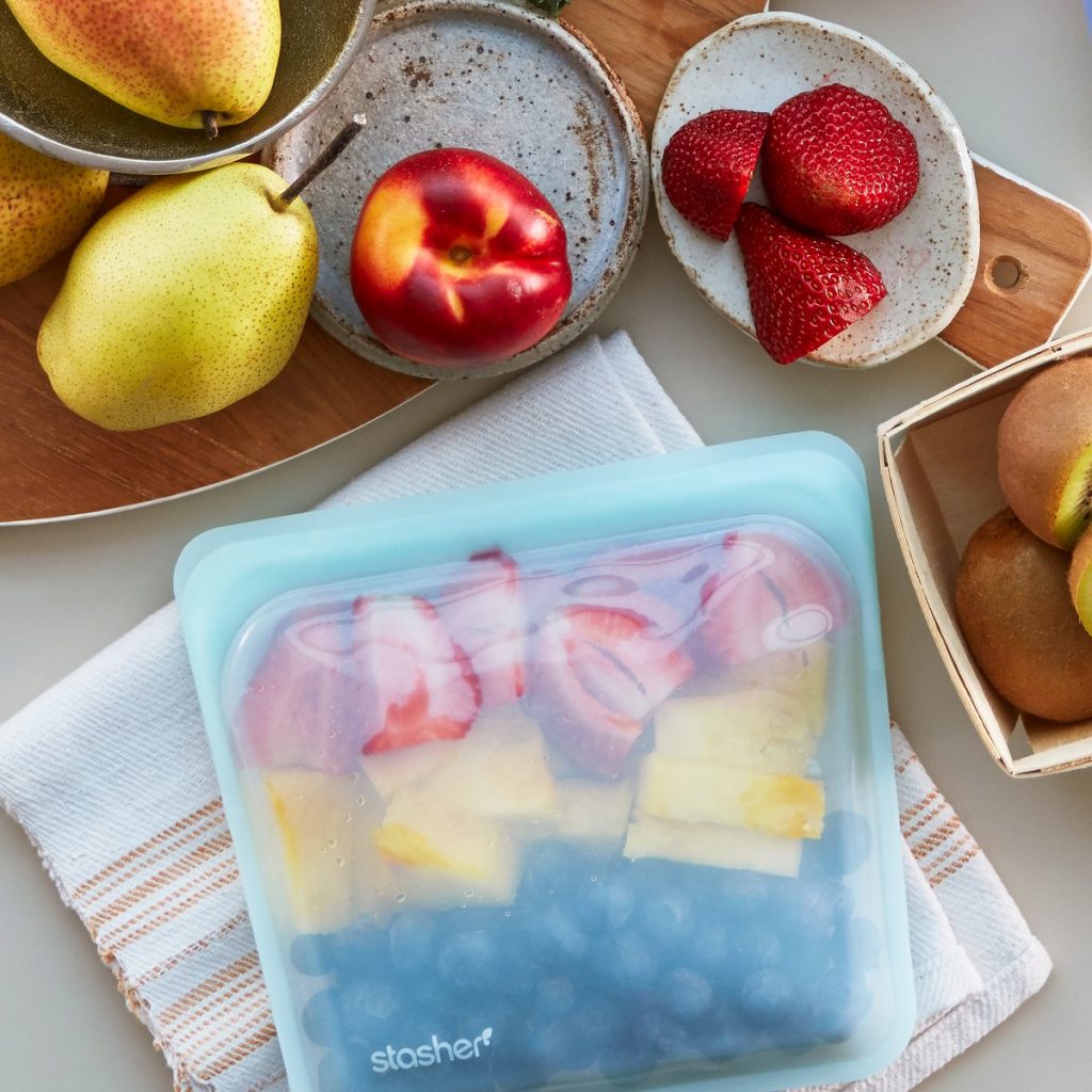 Image Description: Fresh fruit on a set of plates and in a reusable Stashers bag.