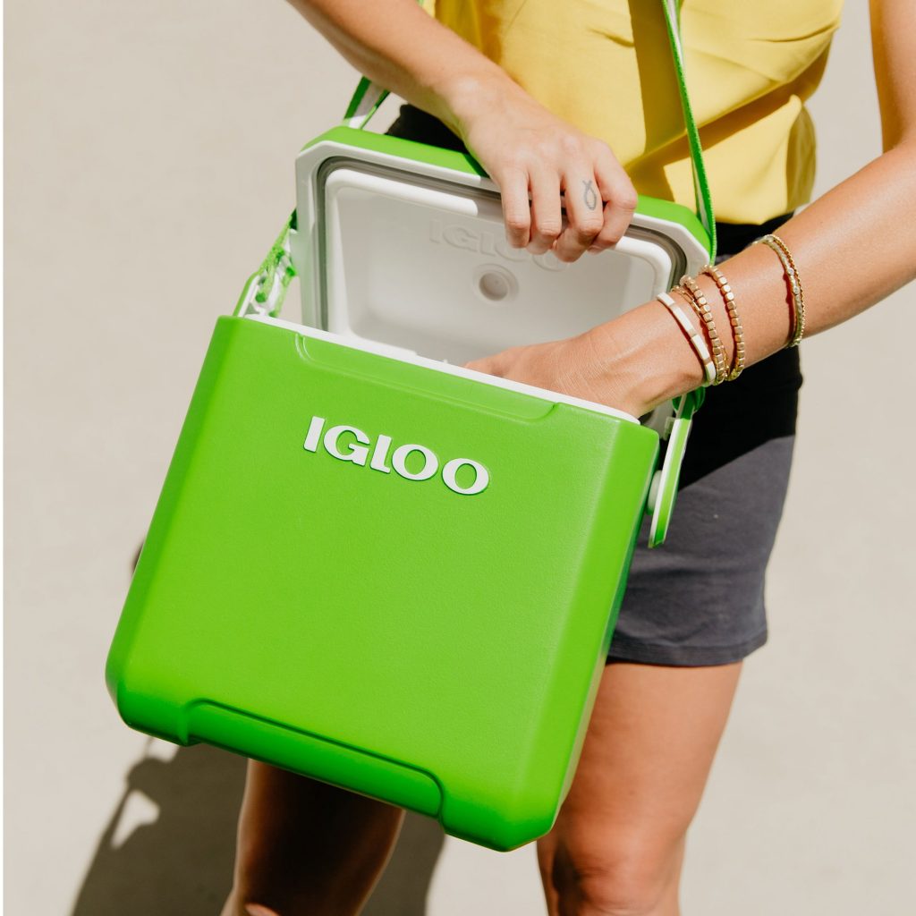 Image Description: A person reaches into a bright green Igloo cooler tote