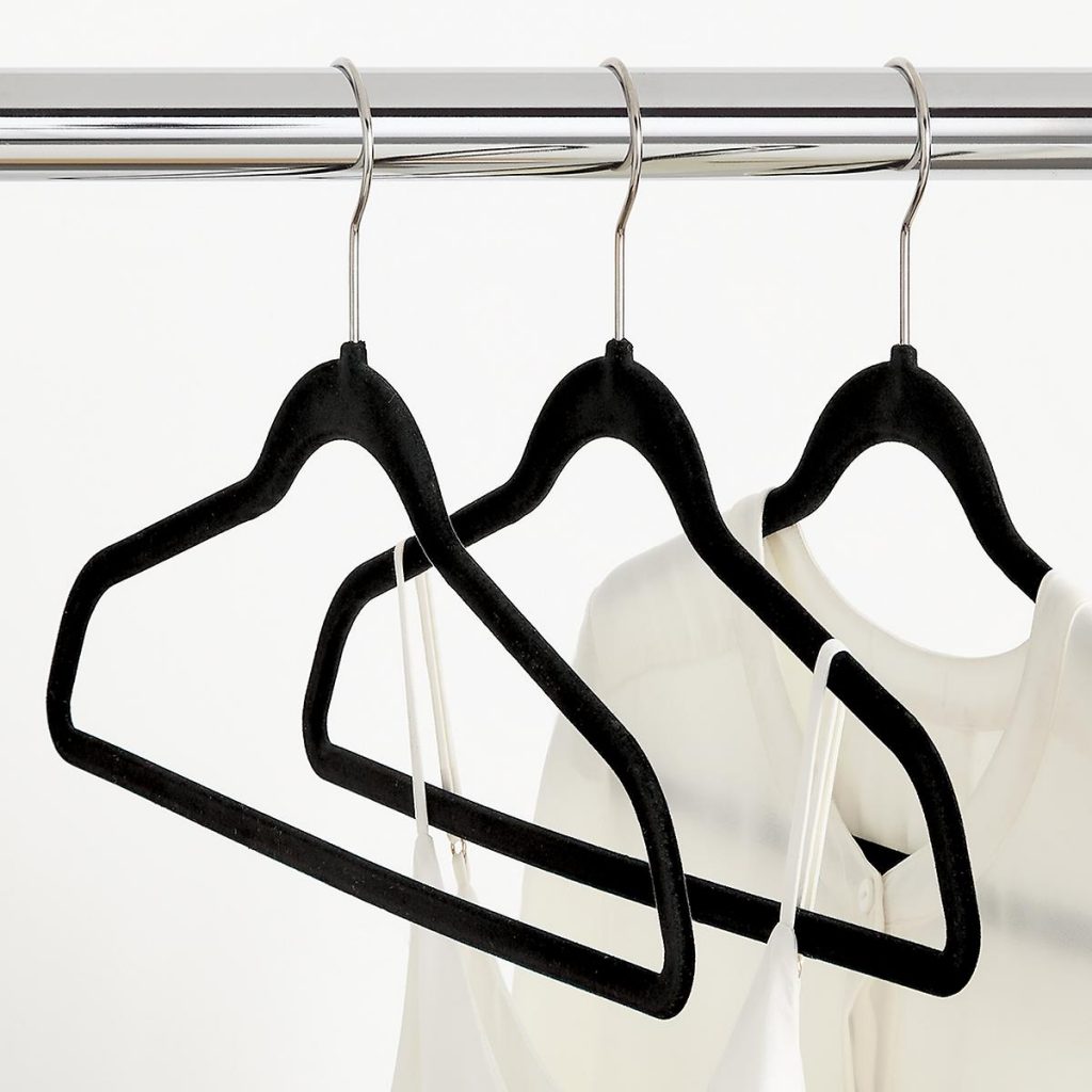 Image Description:Black velvet hangers on a clothing rod